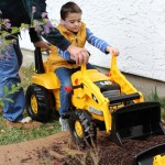 (James digging mulch with Papa.)